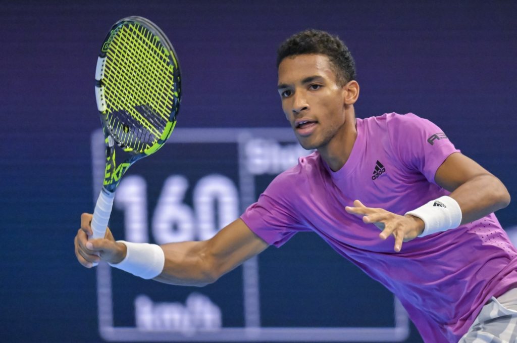 Felix Auger-Aliassime winds up for a forehand.