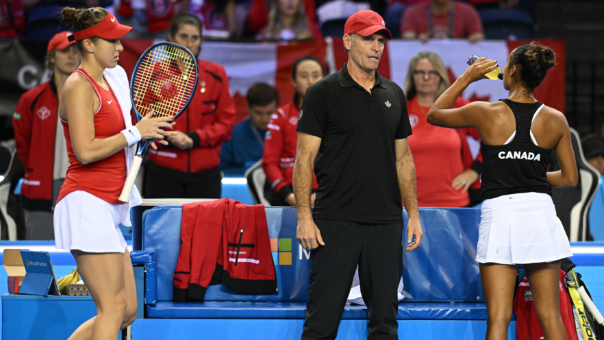 Sylvain Bruneau (middle) talks to Leylah Fernandez (right) as Belinda Bencic walks past.