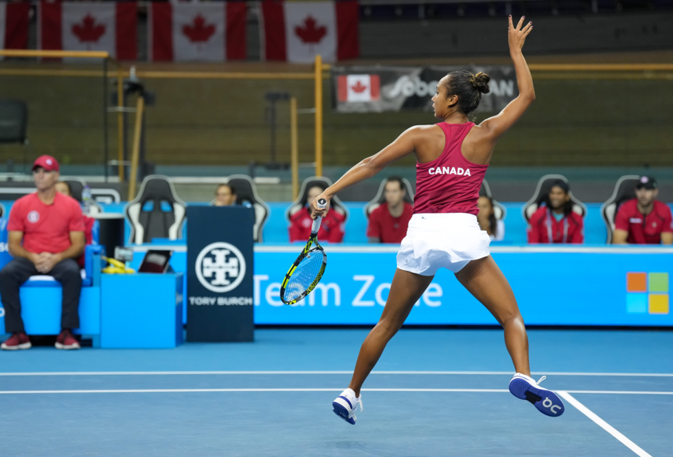 Leylah Fernandez follows through on a leaping backhand volley