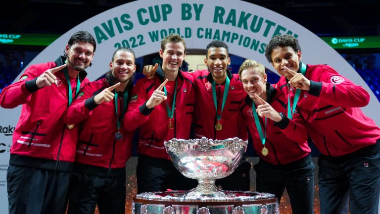 Frank Dancevic, Alexis Galarneau, Vasek Pospisil, Felix Auger-Aliassime, Denis Shapovalov, and Gabriel Diallo stand behind the Davis Cup trophy.