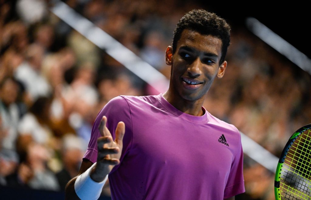 Felix Auger-Aliassime reacts in the direction of the camera.