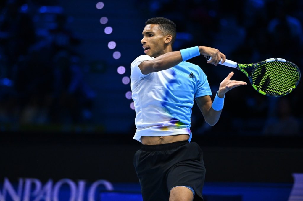 Felix Auger-Aliassime follows through on a forehand