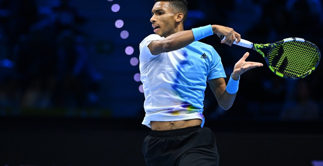 Felix Auger-Aliassime follows through on a forehand