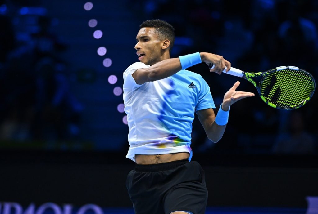 Felix Auger-Aliassime follows through on a forehand