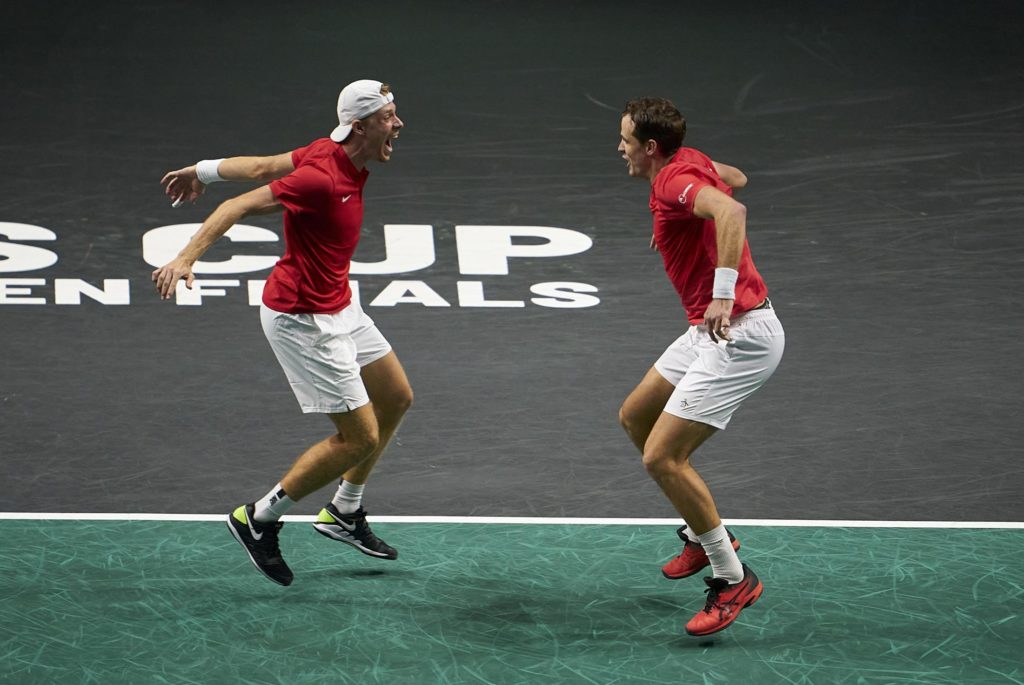 Denis Shapovalov and Vasek Pospisil prepare to leap into each other's arms.