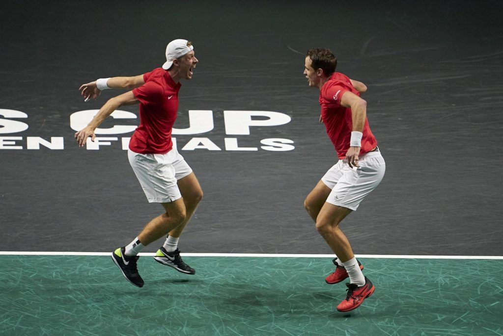 Denis Shapovalov and Vasek Pospisil prepare to leap into each other's arms.