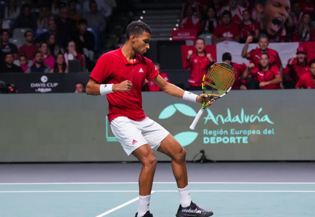 Felix Auger-Aliassime pumps his fist in front of the Canadian bench.