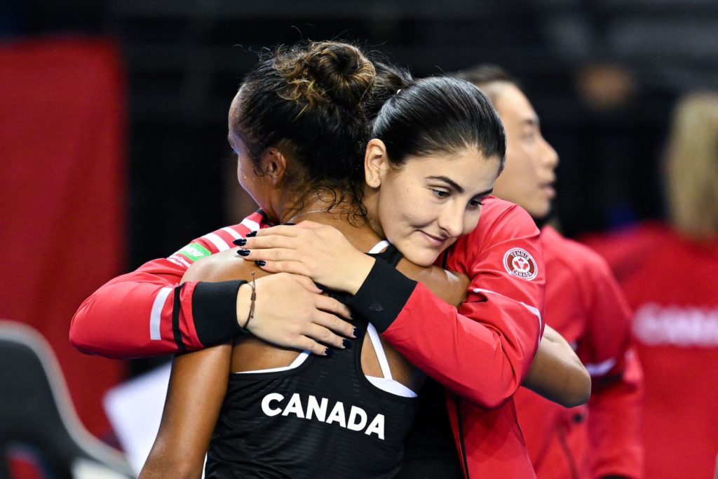Bianca Andreescu hugs Leylah Fernandez (back to camera)