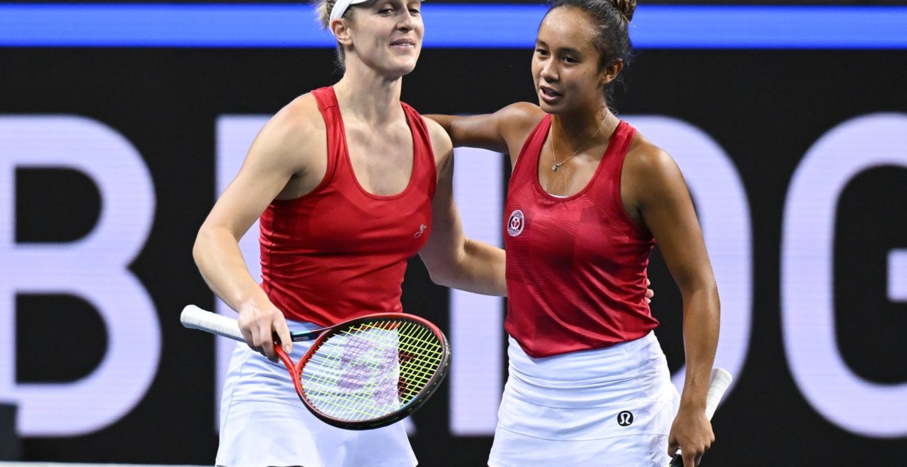 Gabriela Dabrowski and Leylah Fernandez pat each other on the back.