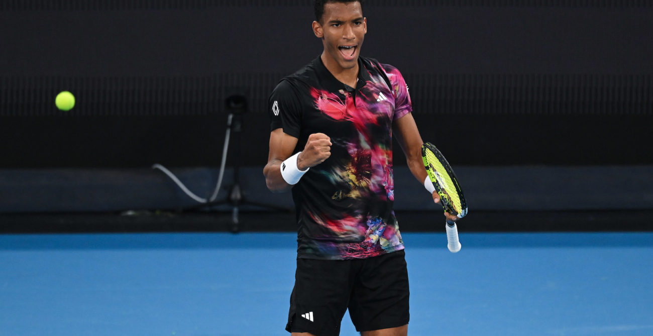 Felix Auger-Aliassime pumps his fist and yells.
