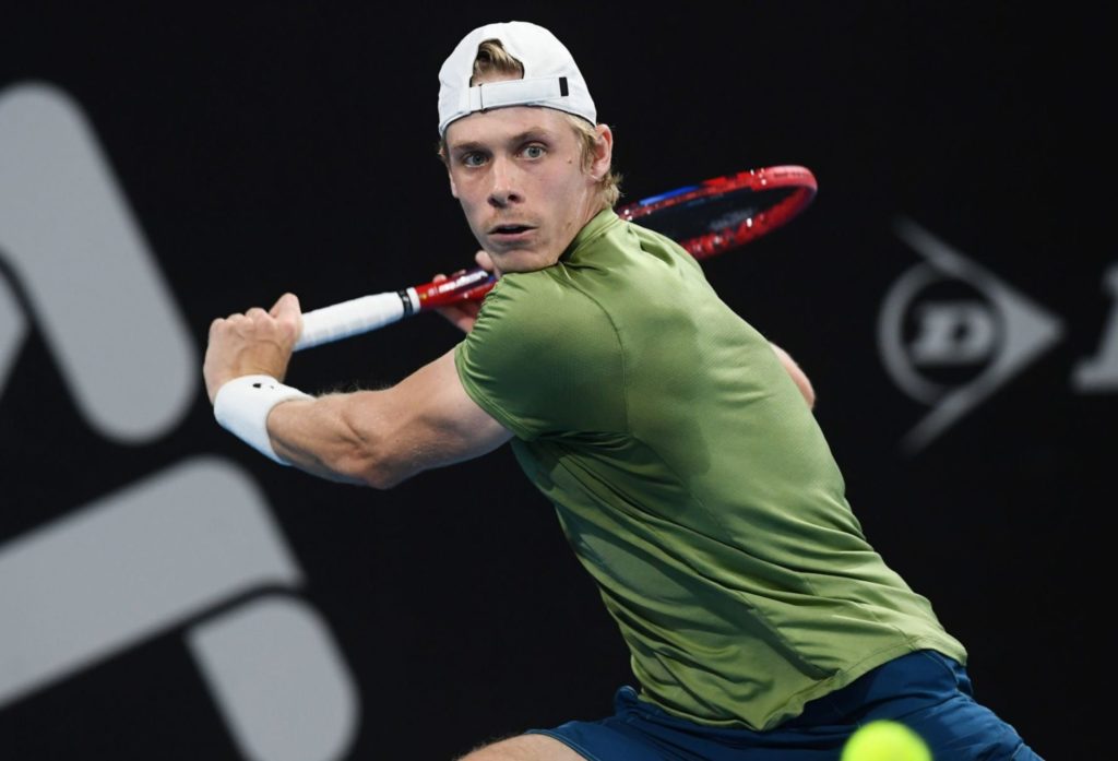 Denis Shapovalov winds up to hit a backhand.