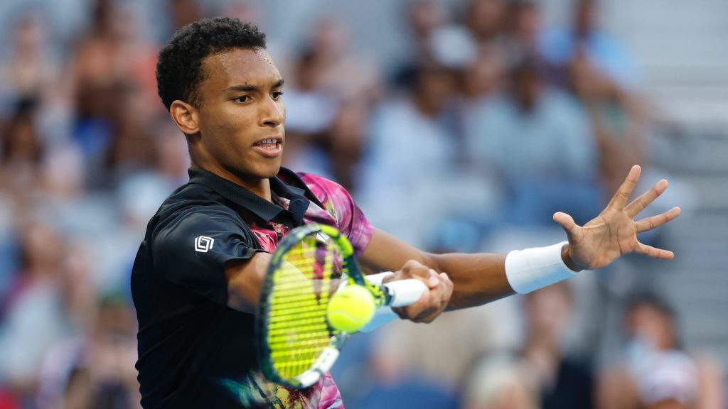Felix Auger-Aliassime hits a forehand.