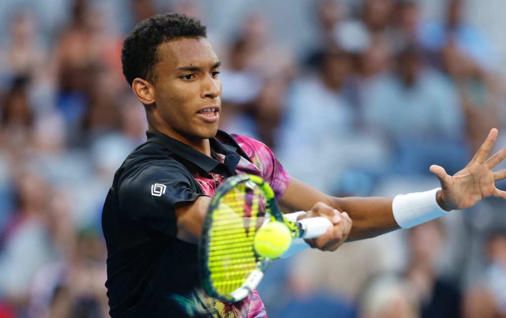 Felix Auger-Aliassime hits a forehand.