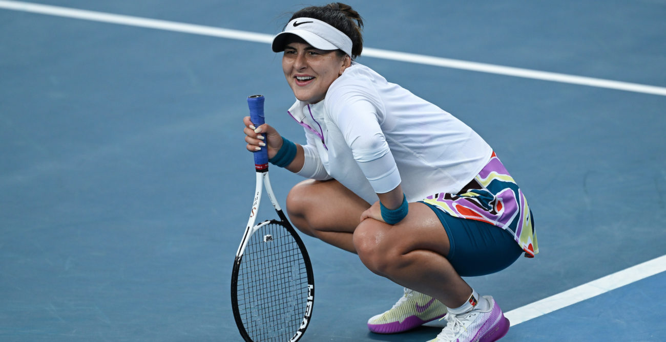 Bianca Andreescu crouches on the court.