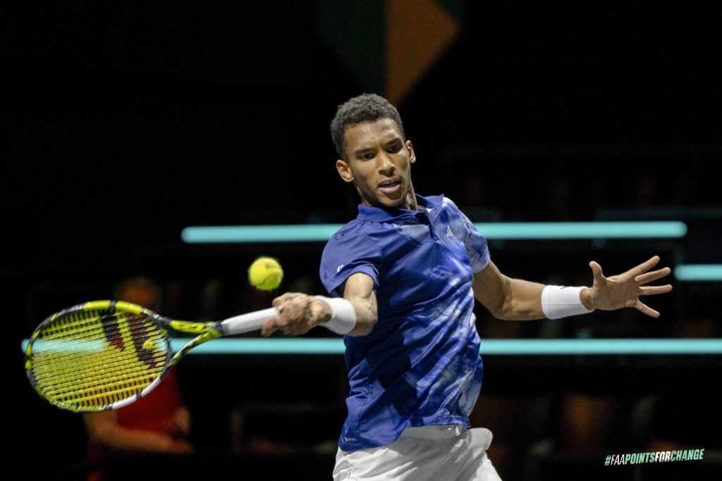 Felix Auger-Aliassime hits a forehand.