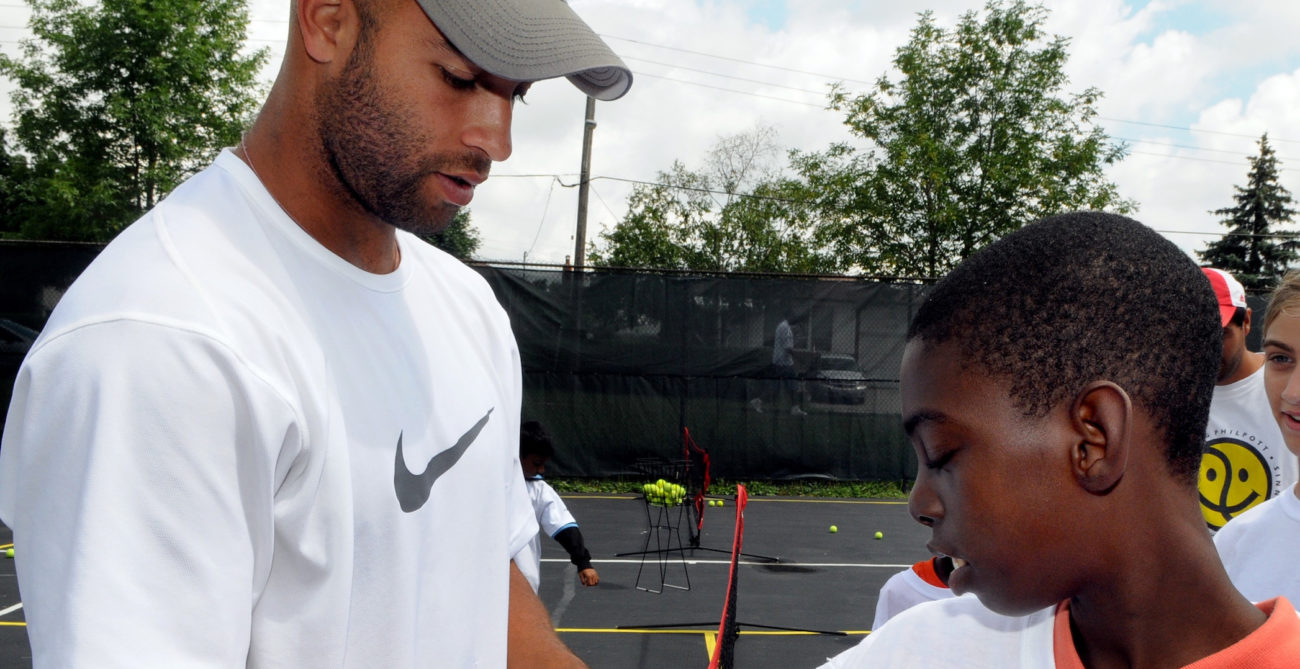 James Blake signs a child's sleeve.