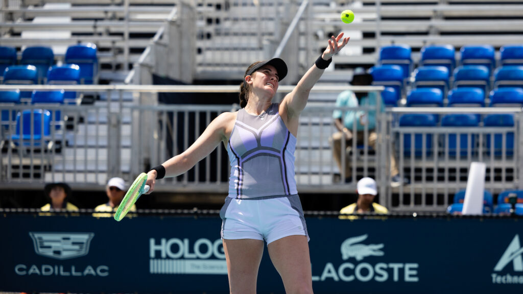 Rebecca Marino tosses the ball up to serve.