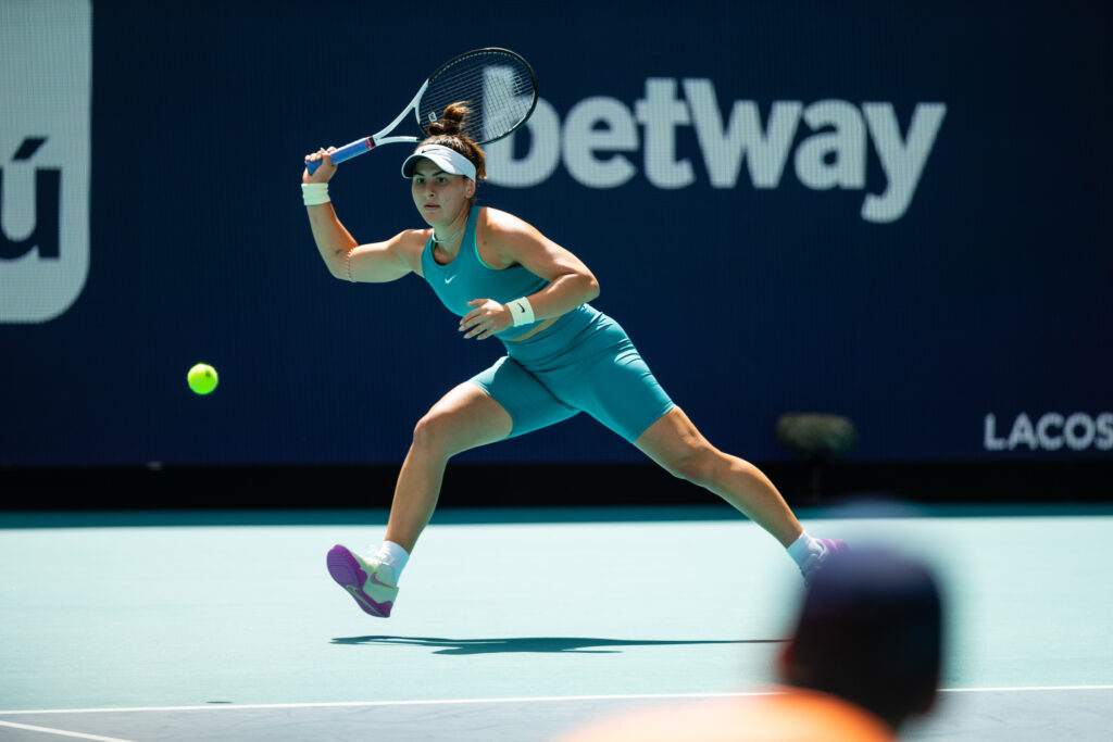 Bianca Andreescu lunges and prepares to hit a forehand.