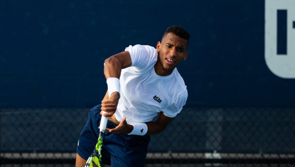 Felix Auger-Aliassime follows through on a serve.