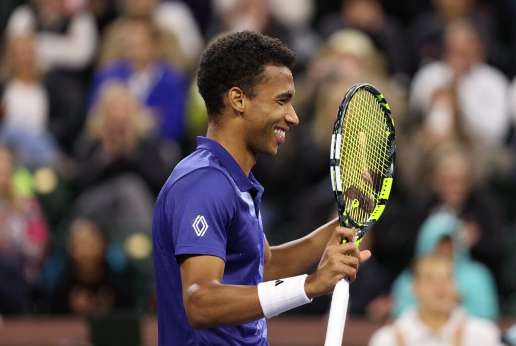 Felix Auger-Aliassime smiles in profile.