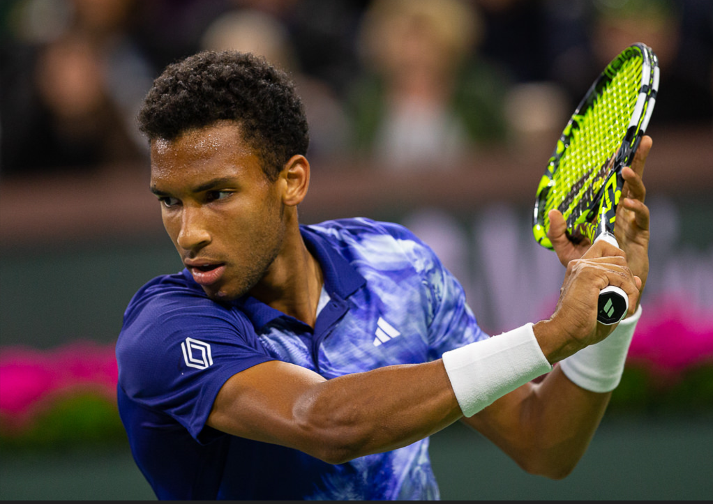 Felix Auger-Aliassime winds up to hit a slice backhand.