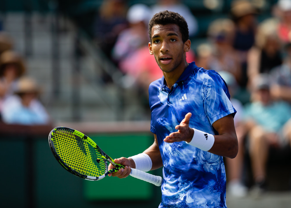 Felix Auger-Aliassime shrugs in frustration.