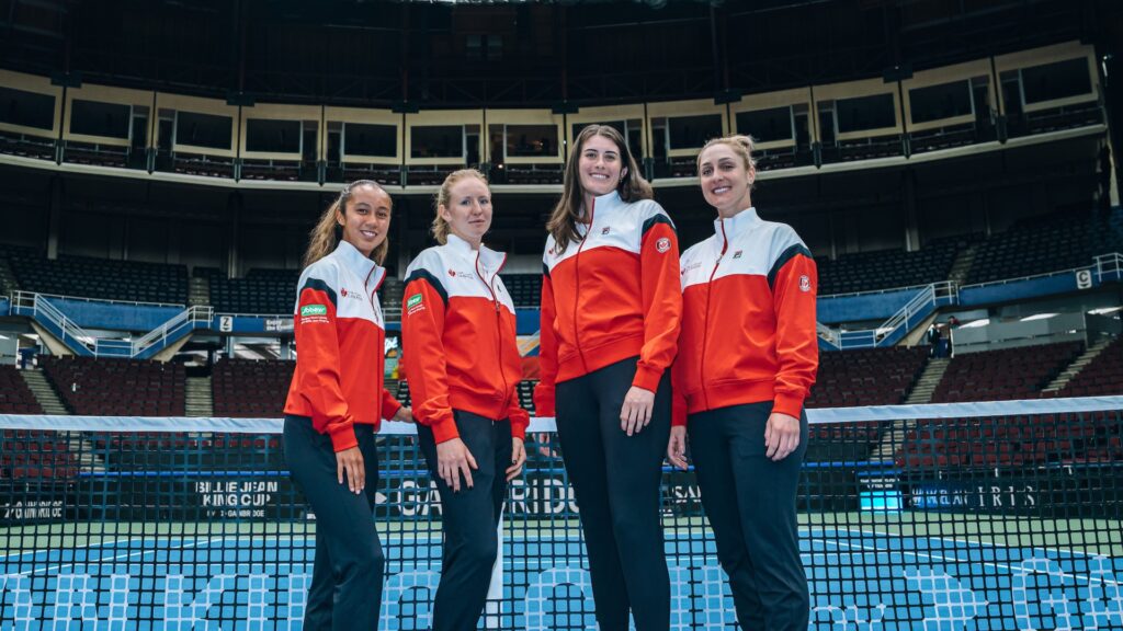 From left to right, Leylah Fernandez, Katherine Sebov, Rebecca Marino and Gabriela Dabrowski stand in front of the net on court.