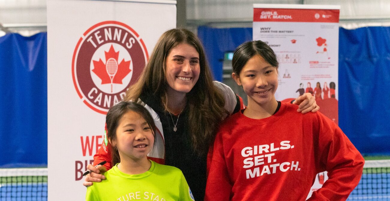Rebecca Marino poses for a photo with two children.