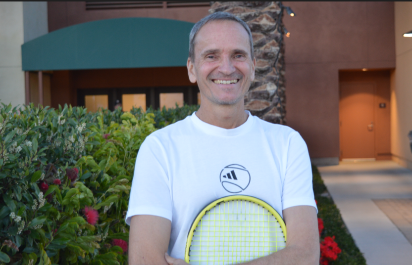 Frederic Fontang smiles and holds a racket.