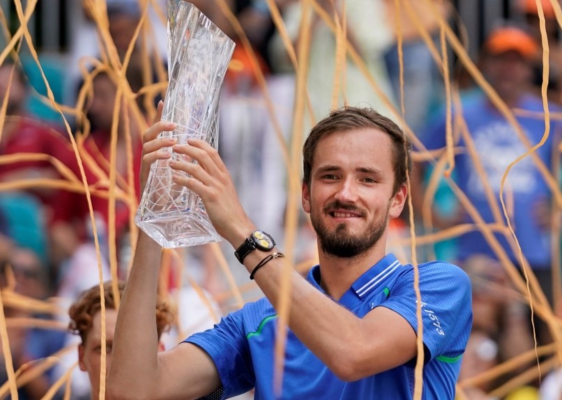 Daniil Medvedev lifts the Miami trophy as orange confetti falls.