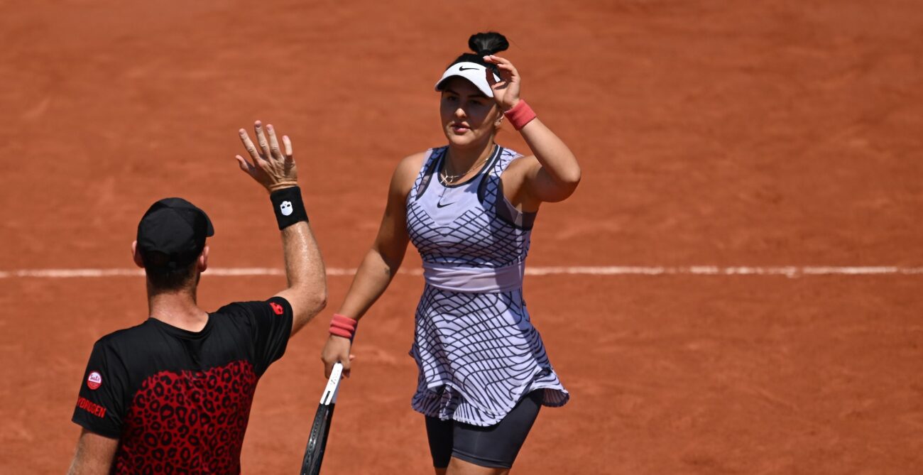 Bianca Andreescu (facing) high fives Michael Venus.
