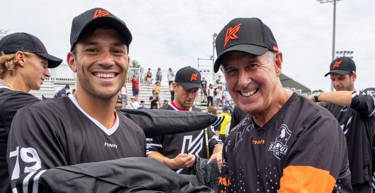Alexis Galarneau (left) and Ron MacLean smile for the camera during the NBO Ball Hockey game.