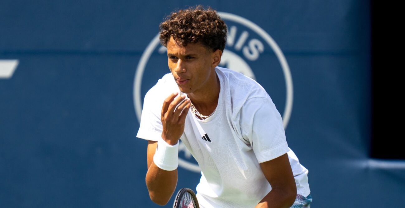 Gabriel Diallo blows on his hand while waiting to return serve.