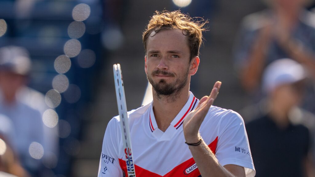 Daniil Medvedev claps on his racket.