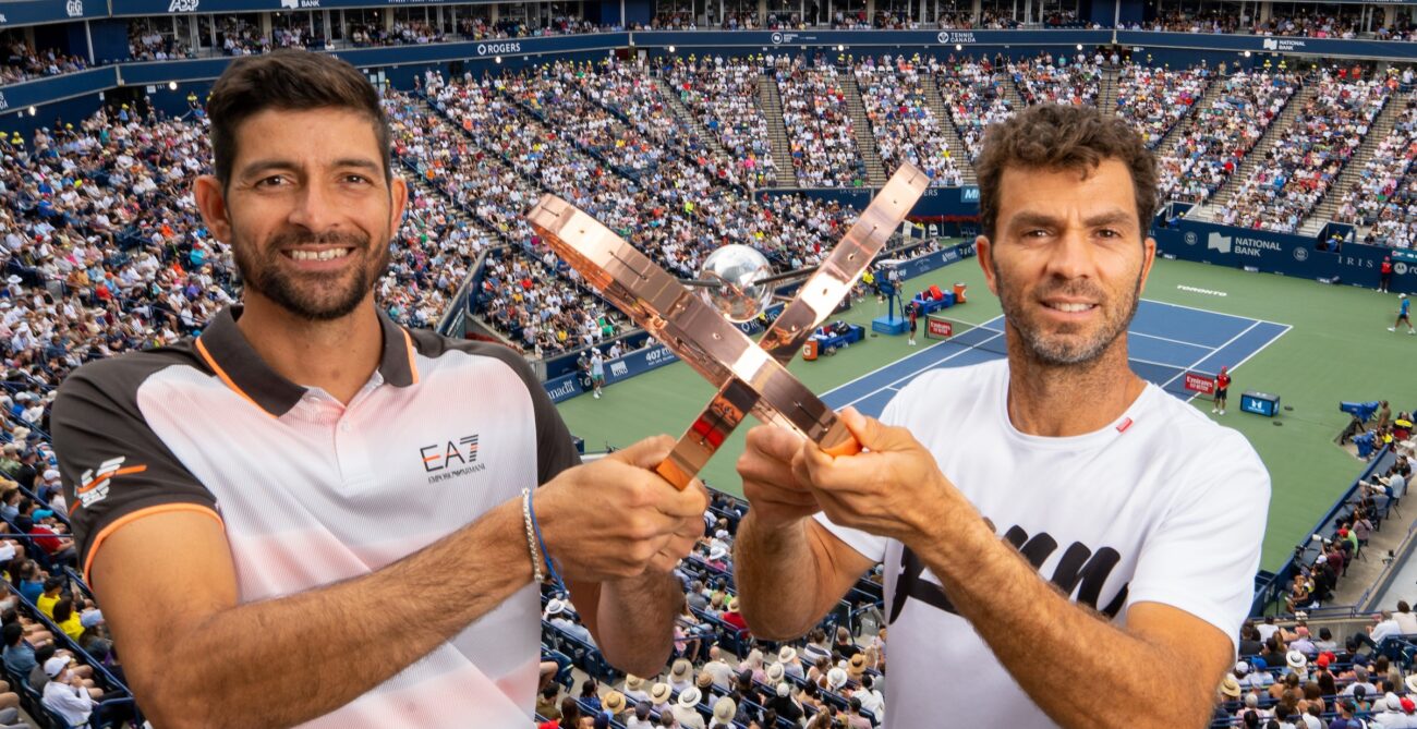 Jean-Julien Rojer and Marcelo Arevalo hold up the trophy in front of the crowd at Sobeys Stadium.