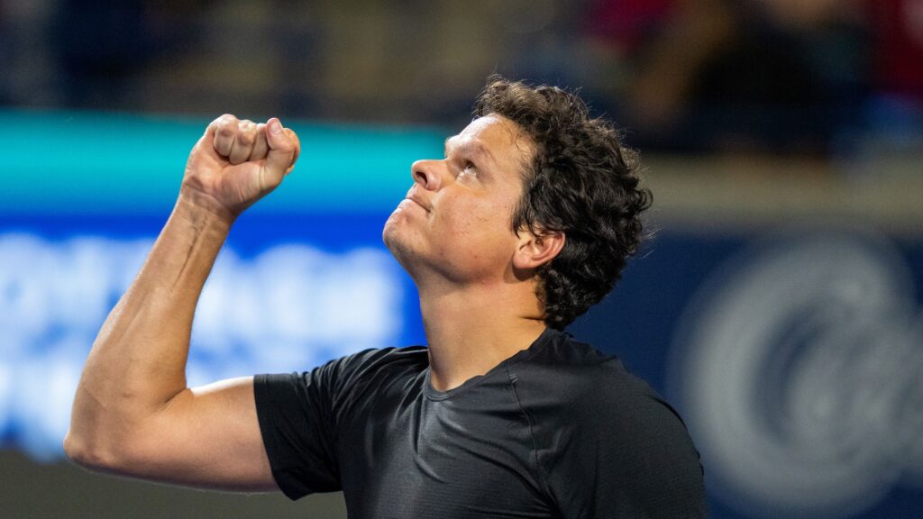 Milos Raonic pumps his and looks up at the sky.