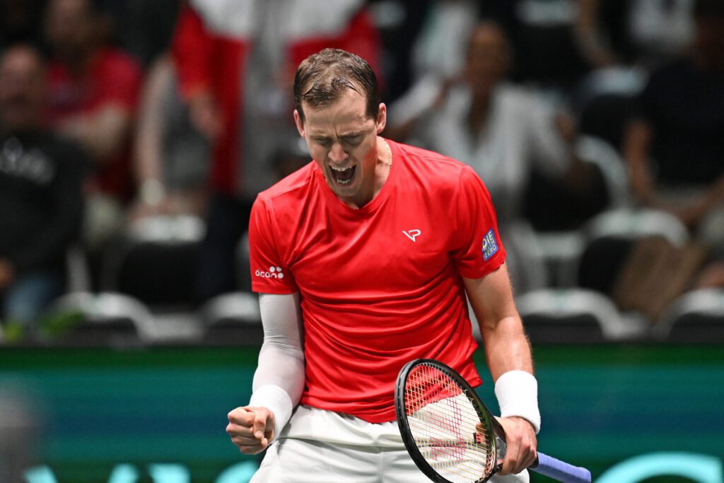 Vasek Pospisil double fist pumps and shouts.