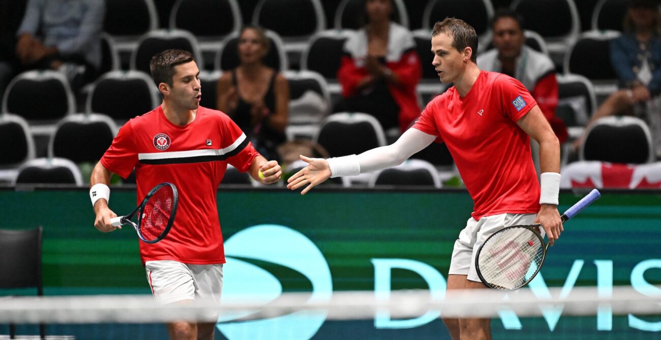Alexis Galarneau (left) high-fives Vasek Pospisil.