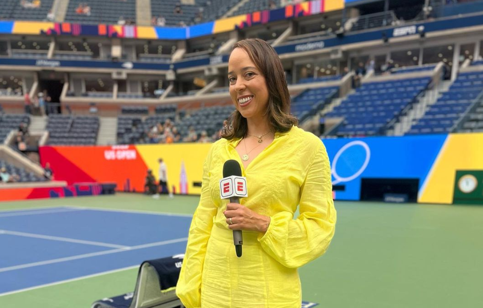 Alexandra Steveson stands in front of Centre Court holding a microphone.