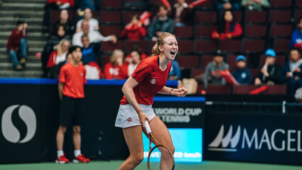Katherine Sebov pumps her fist and yells.