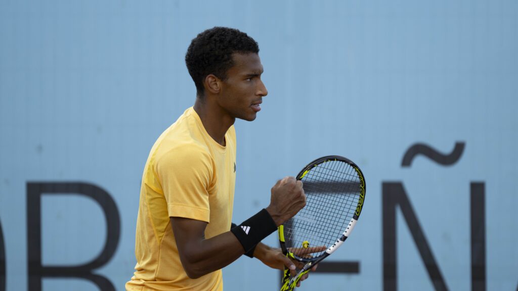 Felix Auger-Aliassime pumps his fist during a win in Madrid.
