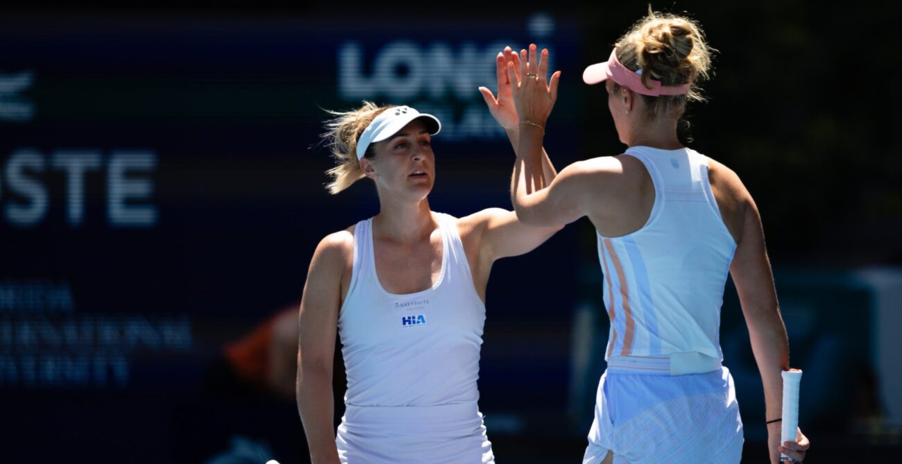 Gabriela Dabrowski (facing camera) high-fives Erin Routfliffe (back to camera) during the Miami Open final.