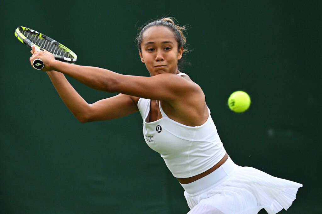 Leylah Fernandez stretches for a backhand in the first round of Wimbledon 2023