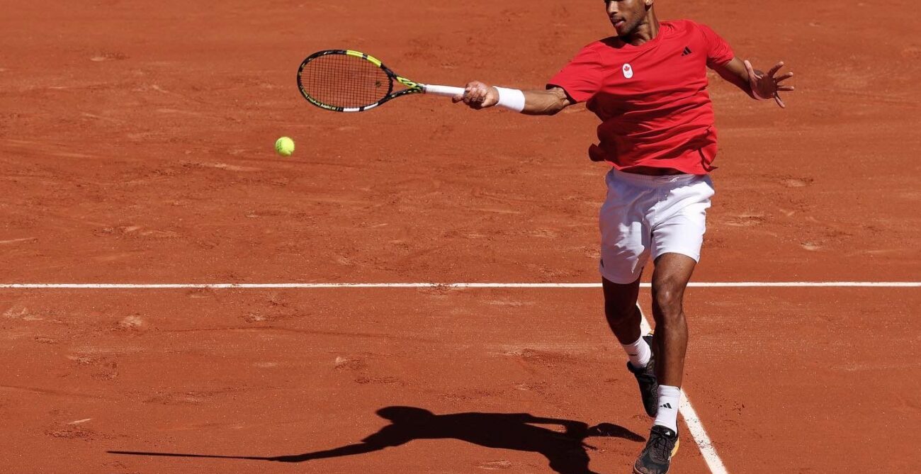 Felix Auger-Aliassime hits forehand in R1 of Paris Olympics