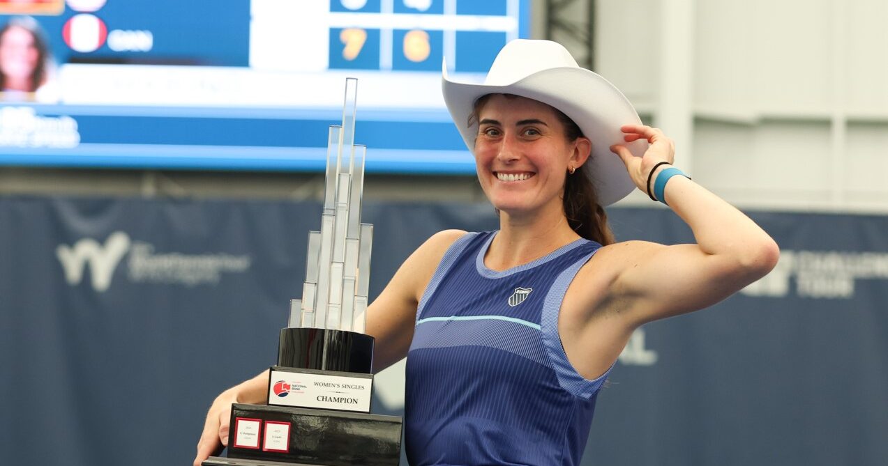Rebecca Marino tips her cowboy hat while holding her Calgary trophy. She and Kayla Cross were both winners at the ITF event.