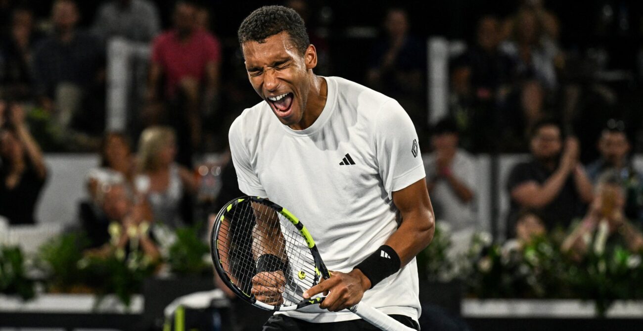 Felix Auger-Aliassime double fist pumps and shouts in celebration. He beat Jan-Lennard Struff on Monday at the Australian Open.