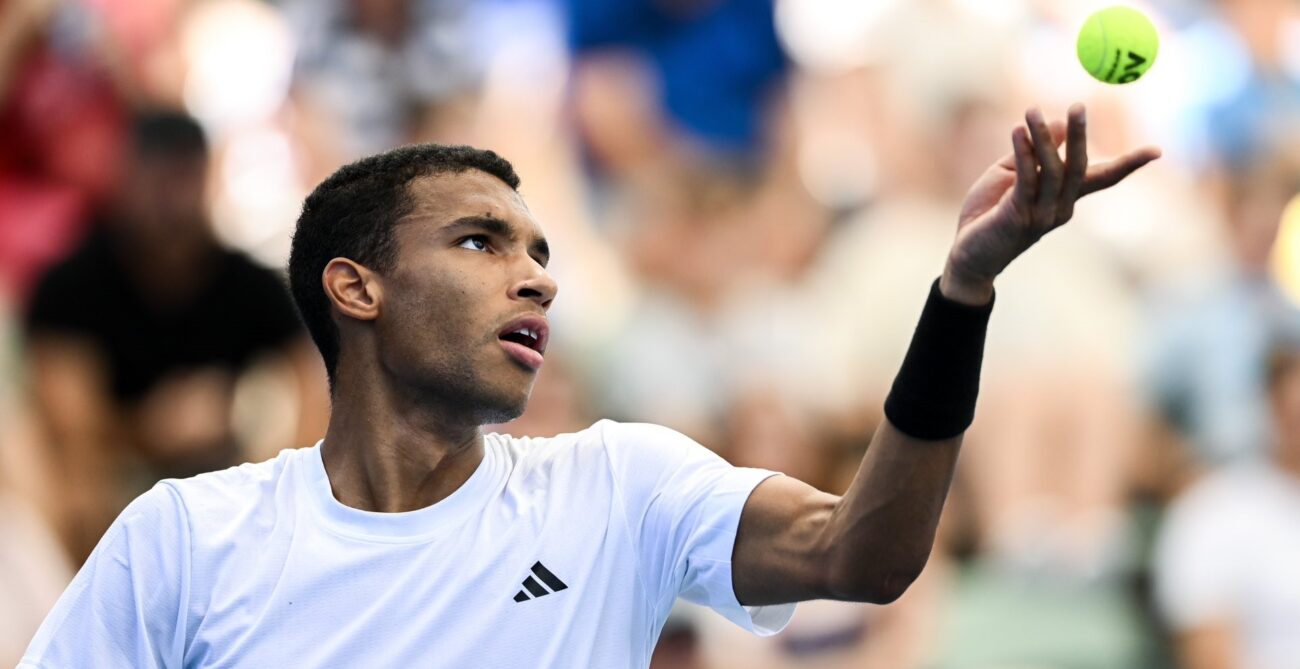 Felix Auger-Aliassime tosses a ball up to serve. He beat Tommy Paul on Friday in Adelaide.