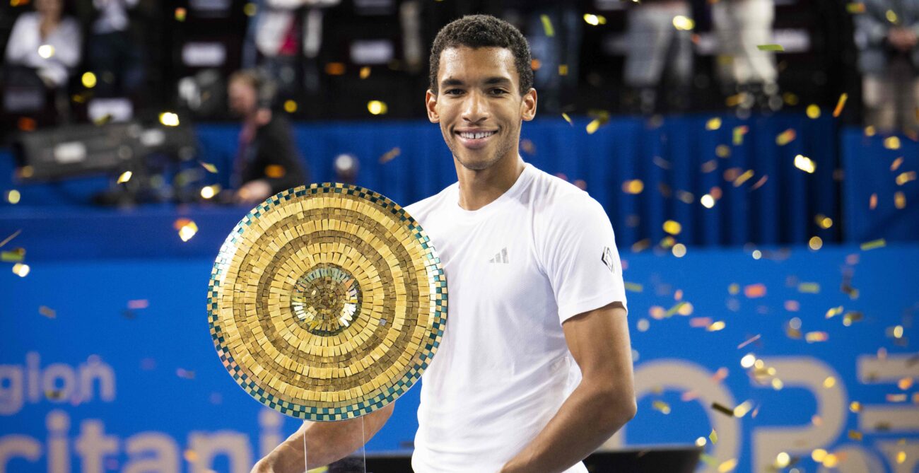 Felix Auger-Aliassime holds up the trophy in Montpellier, his second of 2025.