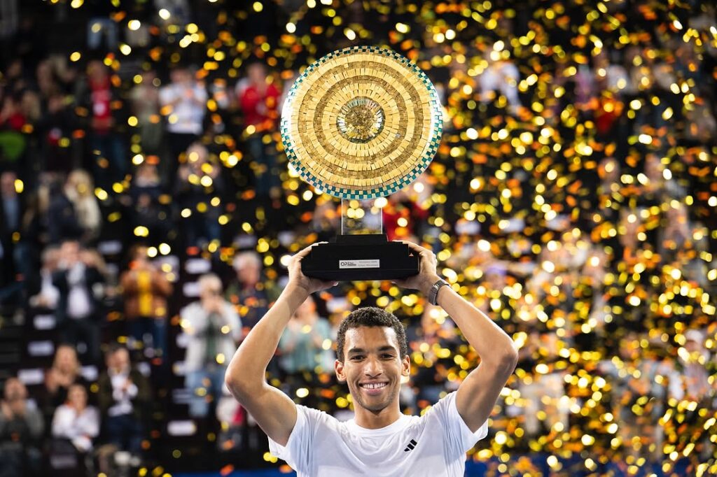 Felix Auger-Aliassime lifts the trophy, his second of 2025, in Montpellier above his head.